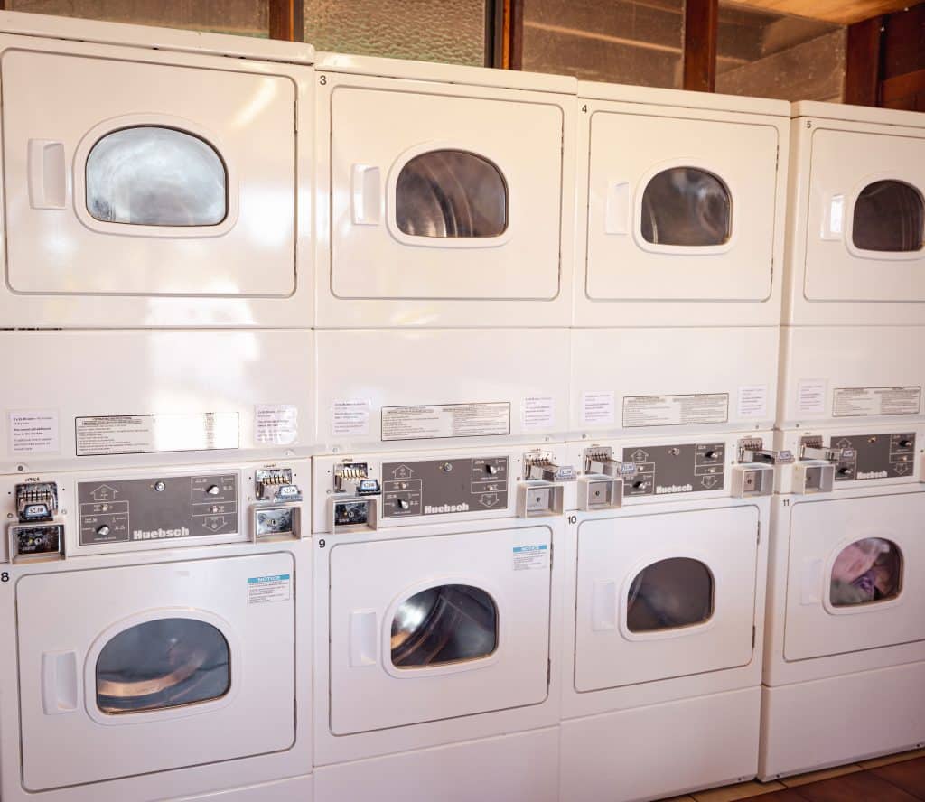 Rows of stacked dryers inside the laundry facility at Fort Victoria RV Park