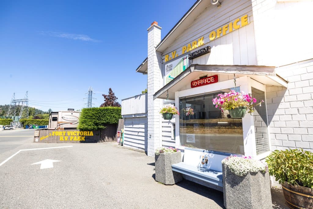 Exterior view of Fort Victoria RV Campground entrance with flowers and signage