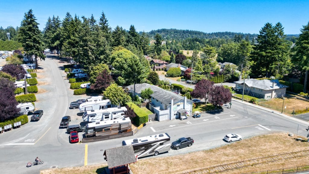 Aerial view of RV park surrounded by lush greenery and trees.