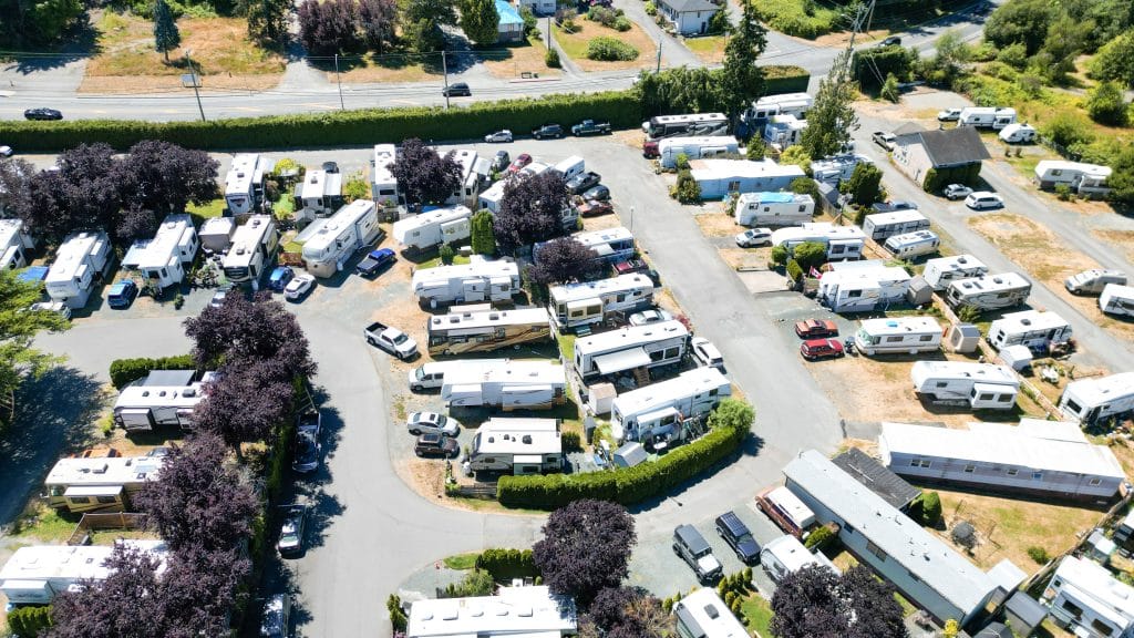Drone shot of RV park showing organized rows of RVs with hookups and roadways.